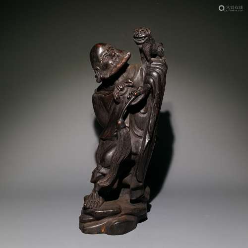 A SANDALWOOD CARVED LIU HAI PLAYING WITH GOLDEN TOAD