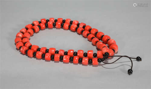 A NECKLACE MADE OF FINELY POLISHEDRED CORAL BEADS
