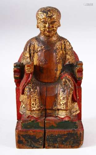 A CHINESE CARVED WOOD & LACQUER FIGURE OF A SEATED BOY -...