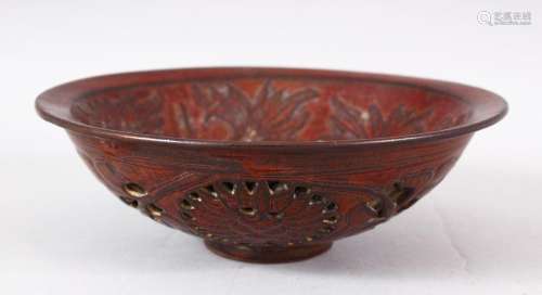 A CHINESE PIERCED POTTERY BOWL - the interior decorated with...