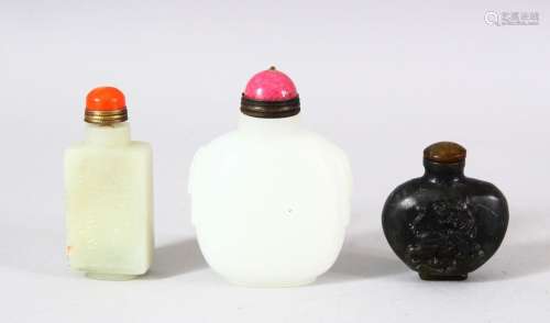 A MIXED LOT OF 3 CHINESE CARVED JADE SNUFF BOTTLES - each of...
