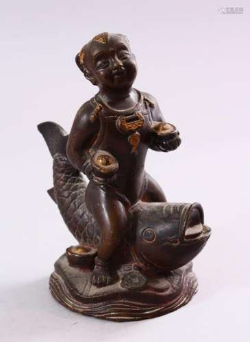 A SMALL CHINESE BRONZE FIGURE OF A BOY SEATED UPON A CARP, 1...