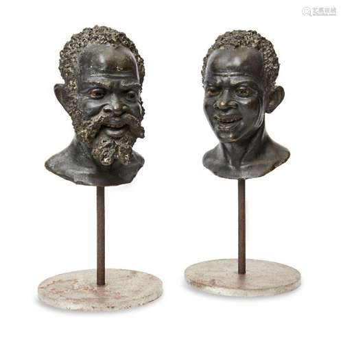 A pair of continental bronze busts of African men, early 20t...