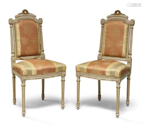 A pair of French white-painted and parcel-gilt side chairs, ...