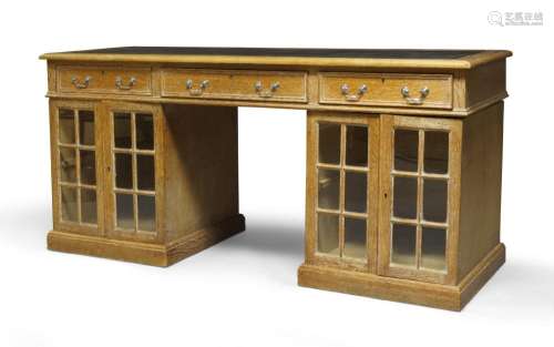 A Victorian limed oak glazed twin pedestal writing desk, c.1...