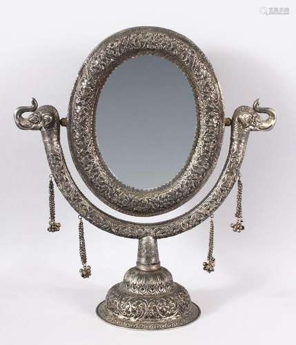 A GOOD INDIAN EMBOSSED WHITE METAL MORROR ON STAND - the mir...