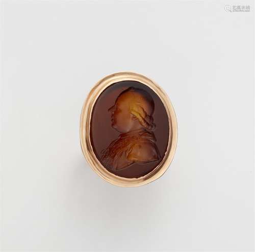 An 18k red gold ring with a paste intaglio portrait of Pope ...