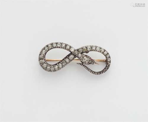 A silver and 14k gold diamond snake brooch