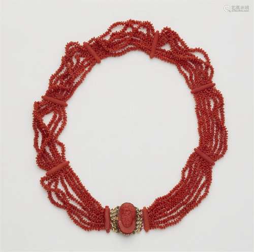 A 14k red gold coral necklace with a shell cameo clasp