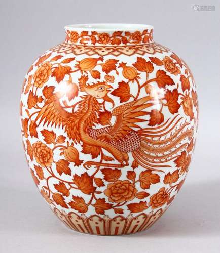 A CHINESE PORCELAIN CORAL RED DRAGON AND PHOENIX VASE, the b...