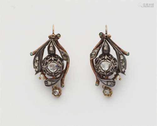 A pair of silver and 14k gold diamond earrings