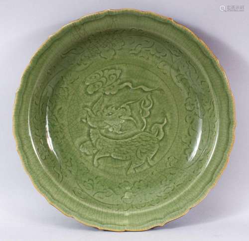 A CHINESE LONGQUAN OLIVE GREEN GLAZED PORCELAIN DISH - the i...