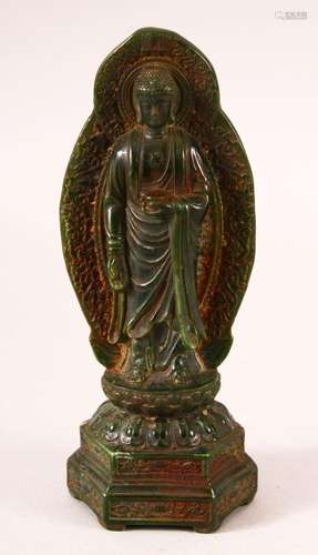 A CHINESE CARVED JADE FIGURE OF BUDDHA, stood upon lotus for...