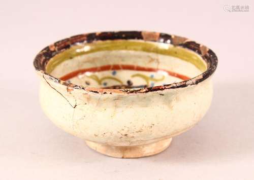 A SMALL ISLAMIC POTTERY BOWL, decorated with two birds, (af)...