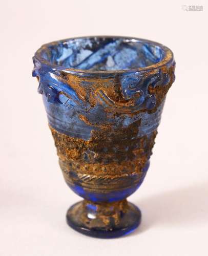 A CHINESE ARCHAIC STYLE BLUE GLASS CUP, decorated with chilo...