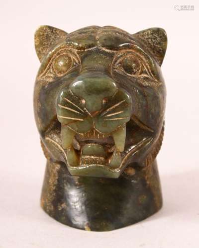 AN INDIAN CARVED JADE TIGER HEAD BUST, the tiger bearing its...