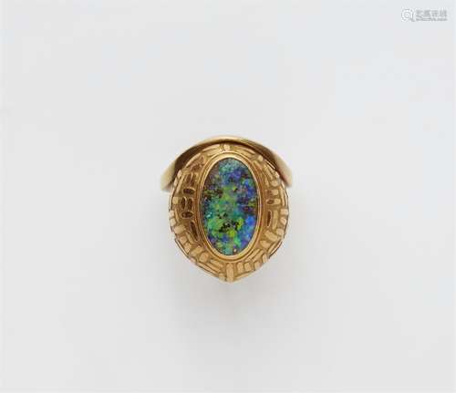 An 18k gold ring with an Andamooka opal