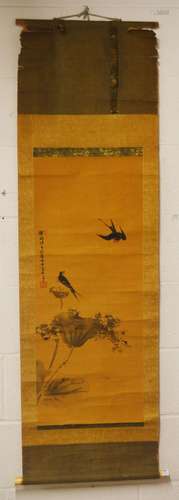 A CHINESE SCROLL PAINTING ON SILK of birds and lotus, signed...