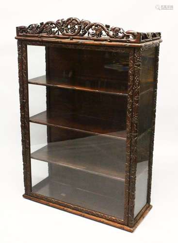 A 19TH CENTURY CHINESE CARVED HARDWOOD AND GLASS DISPLAY CAB...