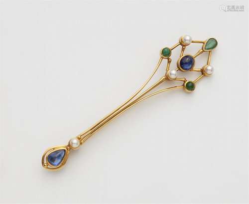 A 14k gold gemstone lapel pin