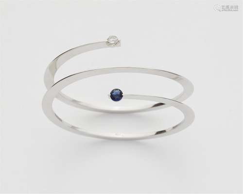 An 18k gold diamond and sapphire spiral bangle