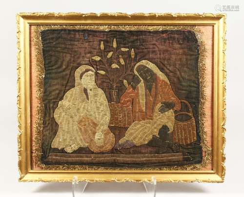 A TURKISH OTTOMAN TEXTILE, depicting two figures, framed and...