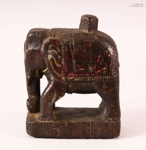 A 17TH CENTURY INDIAN CARVED WOOD FIGURE OF AN ELEPHANT, 14....