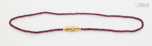 An 18k gold ruby necklace with a diamond clasp