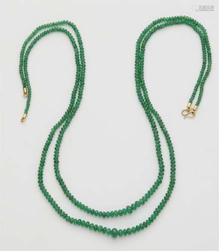 An 18k gold double stranded emerald necklace