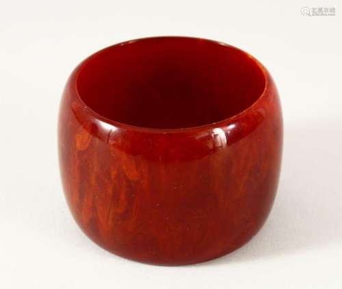 A GOOD ISLAMIC BAKELITE CHERRY AMBER BANGLE - 6cm opening