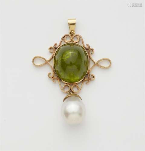 A silver and gold peridot pendant