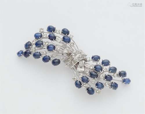 An 18k gold diamond and sapphire cabochon brooch