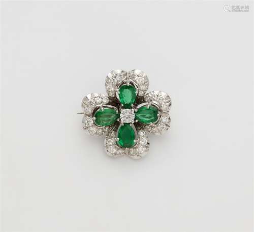 A small 18k white gold emerald brooch