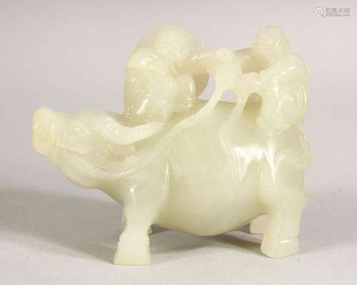 A CARVED WHITE JADE FIGURE riding a buffalo, 9cm long.