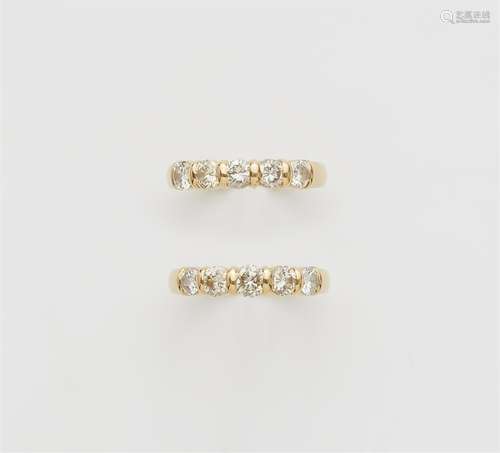 A pair of 18k gold five-stone diamond rings