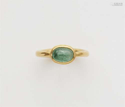 An 18k gold ring with a pale emerald