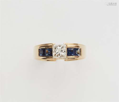 An 18k gold sapphire and diamond solitaire ring