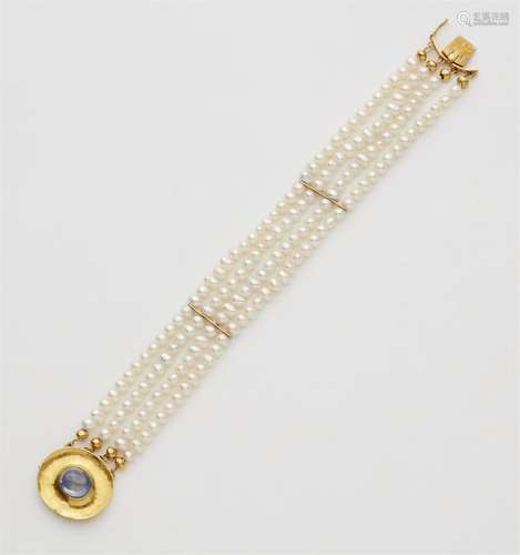 A pearl bracelet with a 22k gold sapphire clasp