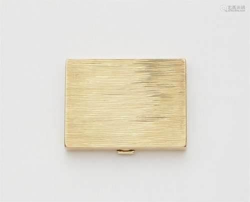 A 14k gold powder compact