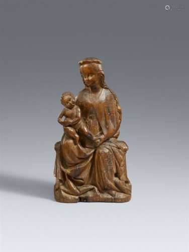 A carved wood figure of the Virgin Enthroned, presumably Cen...