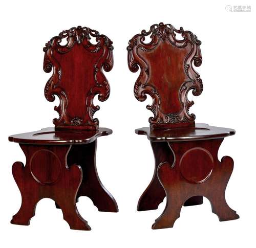 A PAIR OF GEORGE III MAHOGANY HALL CHAIRS