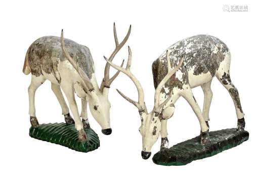 A PAIR OF CARVED AND POLYCHROME WOODEN REINDEER