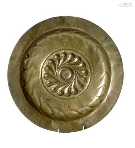 A REPOUSSE BRASS ALMS DISH