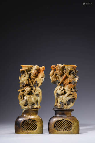 A Pair of Carved Stone Candlesticks