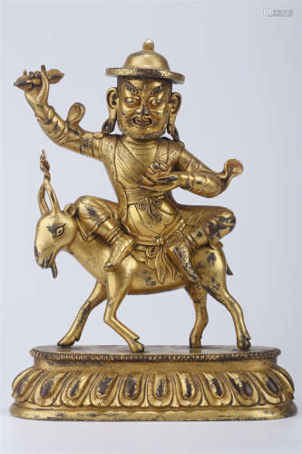 A Gilt Copper Career King Buddha Statue.