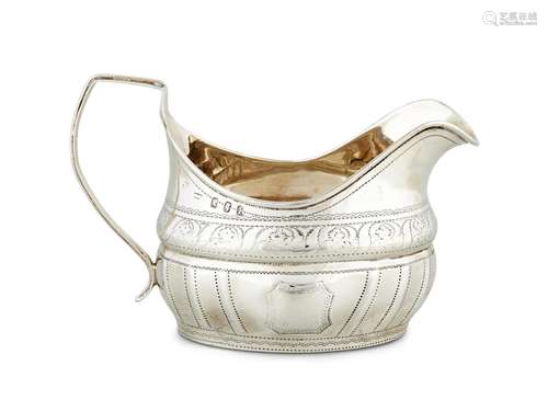 A GEORGE III IRISH SILVER OVAL BRIGHT-CUT CREAM JUG BY DANIE...