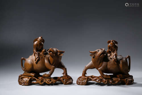 A Pair of Wood Boys and Bull Ornaments