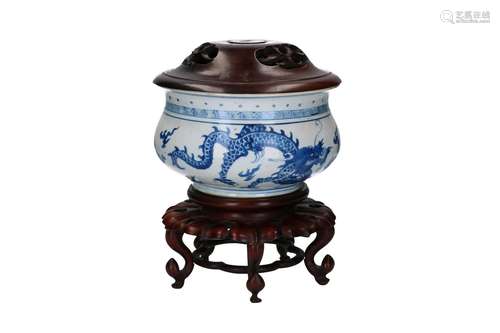 A blue and white porcelain censer with wooden lid, decorated...