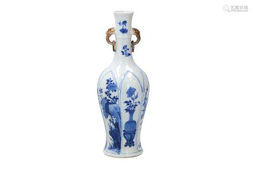 A blue and white porcelain vase with two handles in the shap...