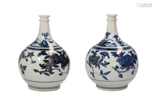 A pair of blue and white vases, decorated with flowers. Unma...